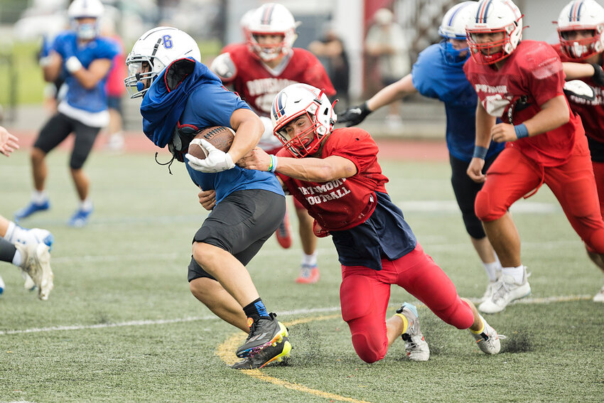 Portsmouth High&rsquo;s Aidan Maisen stops a Middletown running back from advancing the ball during a scrimmage at PHS on Saturday. The Patriots start their season on Friday, Sept. 8.