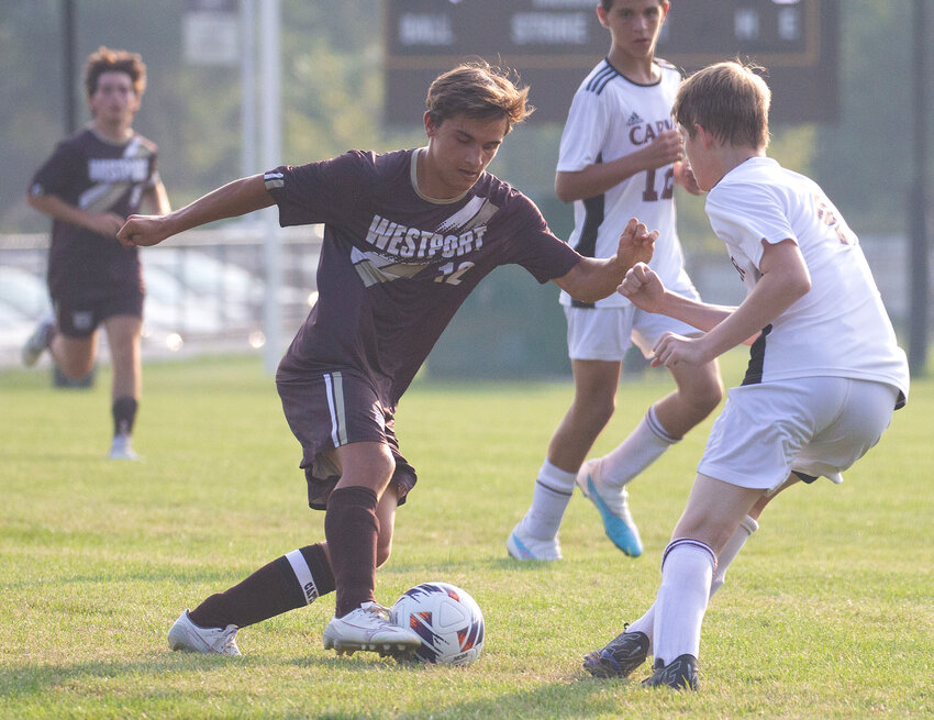 Senior Tommy Bernard dribbles around a defender on his way to the goal as the Westport soccer team crushed Carver 7-1 in their home opener on Wednesday.