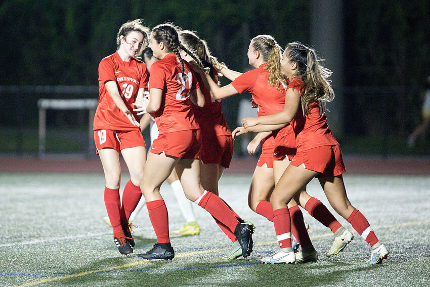The Patriots celebrate a goal scored by Kaelyn Mahoney late in the first half of Tuesday&rsquo;s home game against North Smithfield. Portsmouth won, 2-0.