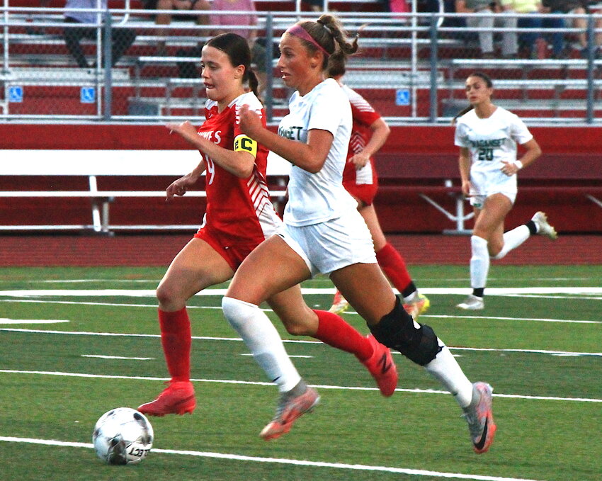 EPHS captain Eva Laroche (left) and a Ponaganset opponent chase down a free ball during the teams' Division II girls' soccer contest September 14 in city.