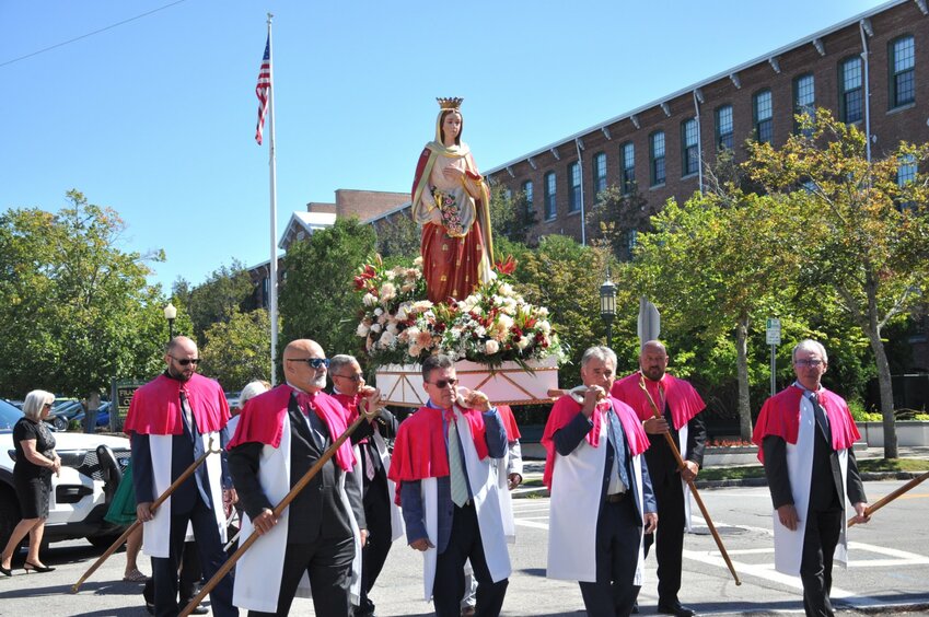 The statue of St. Elizabeth of Portugal is carried proudly through local neighborhood streets on a day filled with religious history.