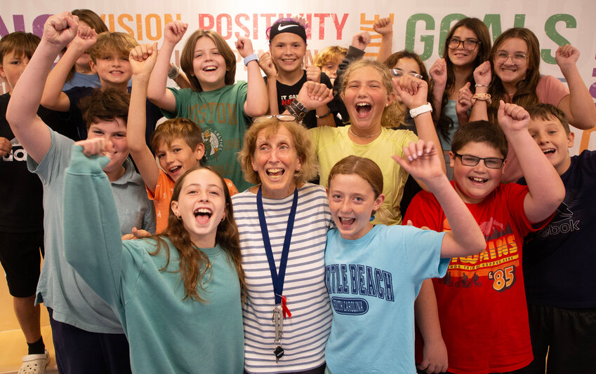 Barrington Middle School math teacher Connie Oswald (front row, middle) is surrounded by happy students. Oswald was named Barrington&rsquo;s Teacher of the Year.