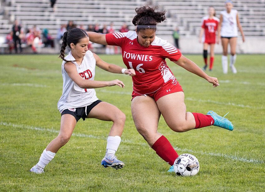 PCD's Sadie Henriques (left) attempts to defend a pass being made by East Providence's Amanda Lopes in the teams' non-league girls' soccer outing September 22.