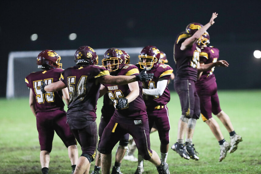The Tigers celebrate after holding off Smithfield 7-6 in overtime during a Division IV home game on Friday night.