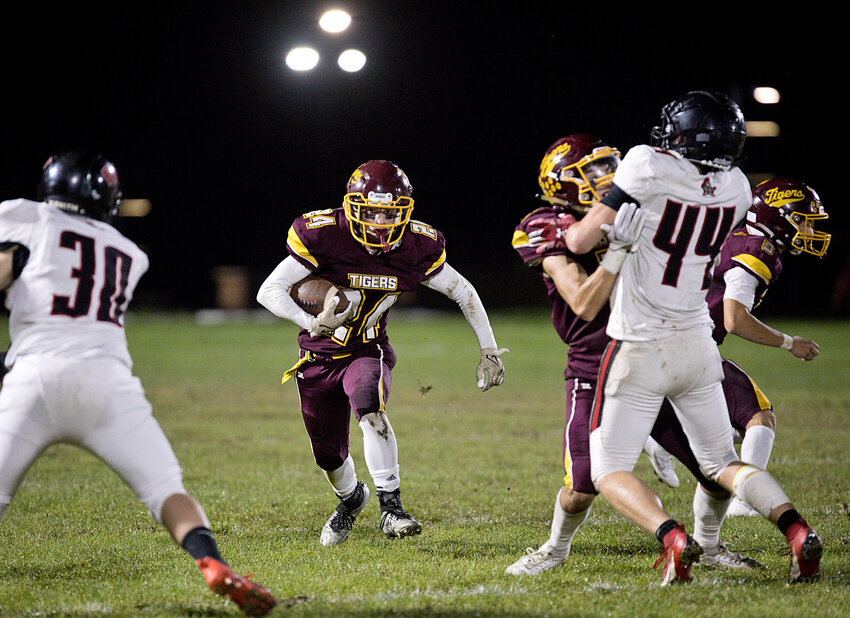 Evan Lapointe finds a hole while running the ball for Tiverton.&nbsp;