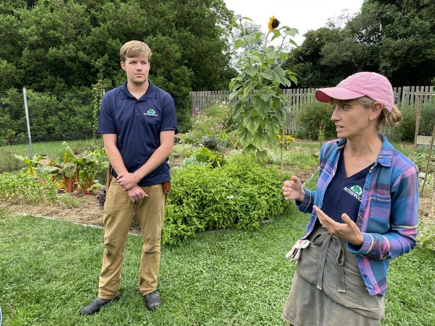 Blithewold Gardens and Greenhouse Manager Betsy Ekholm (right) talks about their vegetable gardens, which grew with a new irrigation system this year, thanks in part to intern Ollie Bingham (left).