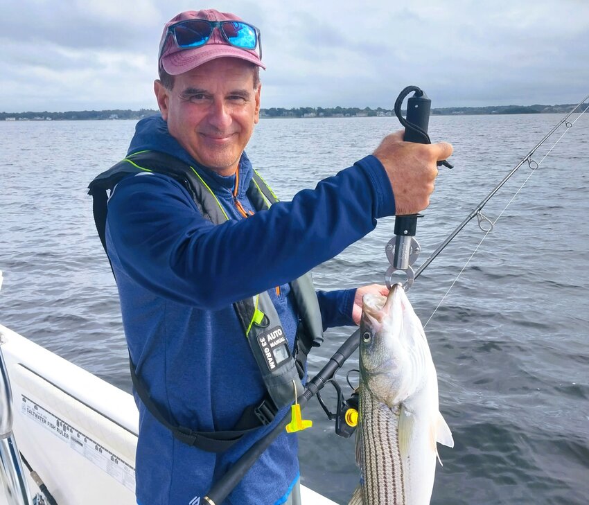 Joe Rochira of Warwick, with one of the three striped bass he caught this weekend trolling tube &amp; worm on the east side of the shipping channel in front of Barrington Beach.