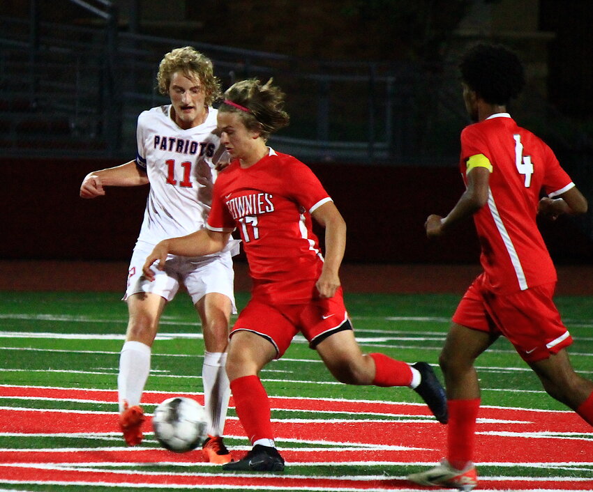 East Providence's Sam Jackson (center) vies with Portsmouth's Landon Rodrigues for possession during the teams' Division I boys' soccer game October 11. Jackson netted both goals in the contest, a 2-0 win for the host Townies in East Providence.