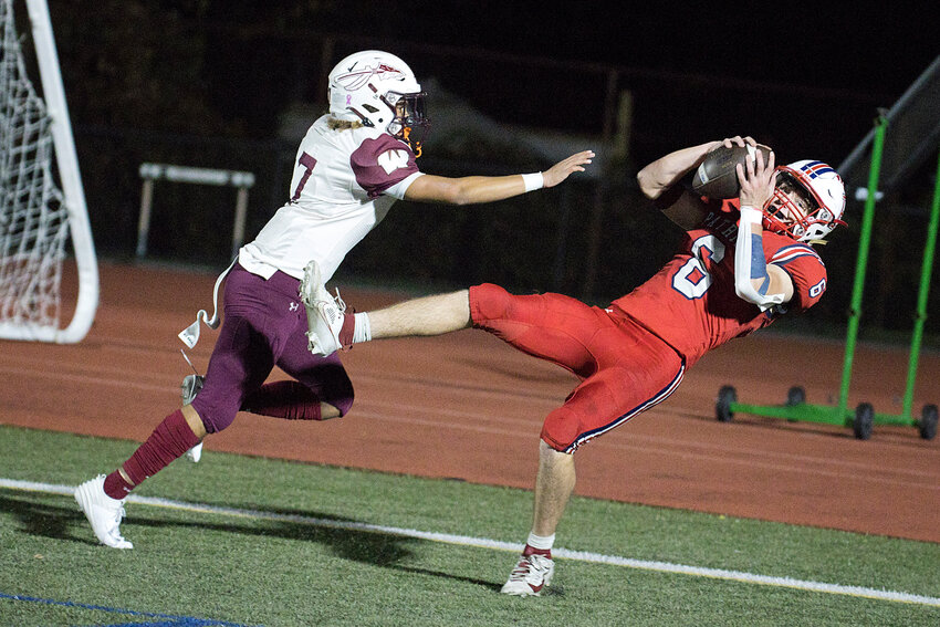 Portsmouth High&rsquo;s Tyler Hurd catches a touchdown pass during the first half of Friday&rsquo;s home game against Woonsocket, won by the Patriots by a score of 25-14.