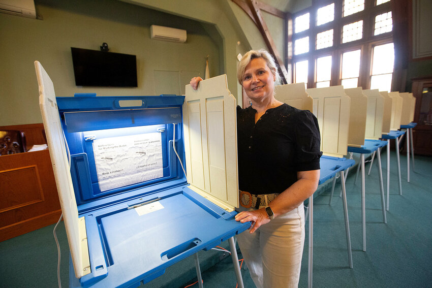 Barrington Deputy Town Clerk Stephanie Bernardo stands near a voting booth. In Barrington, there will be three polling locations open for the Nov. 7 election: the high school, the middle school and Hampden Meadows School.