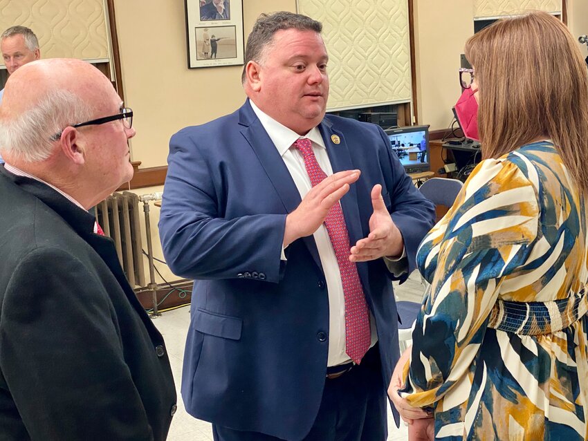 Incoming police chief Christopher Dunn (center) talks with select board chairman Richard Brewer and board member Shana Shufelt following Monday&rsquo;s vote.