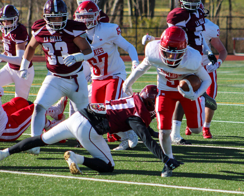 East Providence receiver Isaac Fox breaks through a would-be LaSalle tackler during the teams' annual Thanksgiving Day football game November 23.