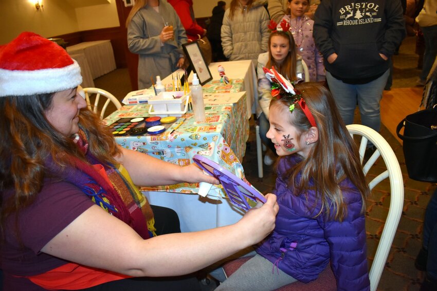 Drea Cabral, 6 (right), liked what she saw after her face-painting session with Debbie Salamon.