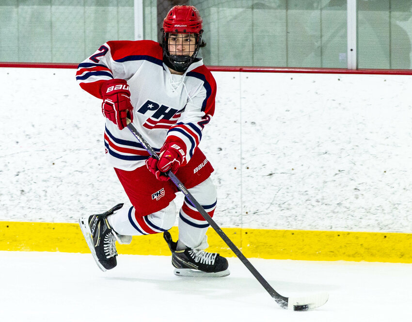 Patriots freshman defenseman Rafe Dionne looks to make a pass in the defensive zone against Mt. Hope-East Providence on Saturday.