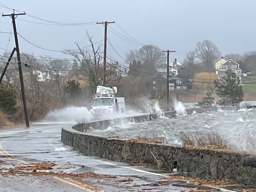 Poppasquash Road in Bristol was completely inundated with water as the surrounding waters approached high tide.
