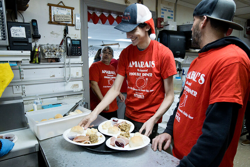 Amaral's staff line trays with holiday meals as a steady flow of customers fills the dining area.