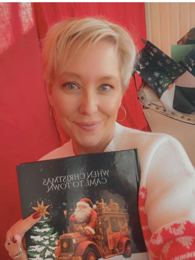 Jodi Leffingwell, a Bristol-based author, poses with her newest book, &ldquo;When Christmas Came to Town&rdquo;.