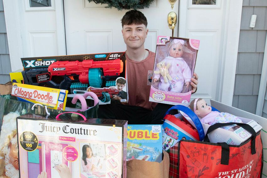 Joseph Earley, 18, gathers donated toys on Saturday before delivering them to the Cardi's in Seekonk for their Toys for Tots drive.