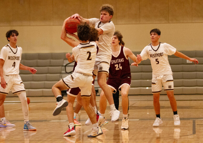 Owen Boudria looks on (left) as teammates, Max Gallant and Chris Duarte fight for a rebound during the Wildcats loss to Bishop Stang on Tuesday. Anthony Raposa is at right.&nbsp;  The Wildcats turned things around and pounded St. John Paul II 70-33 in a non-league home game on Thursday night.