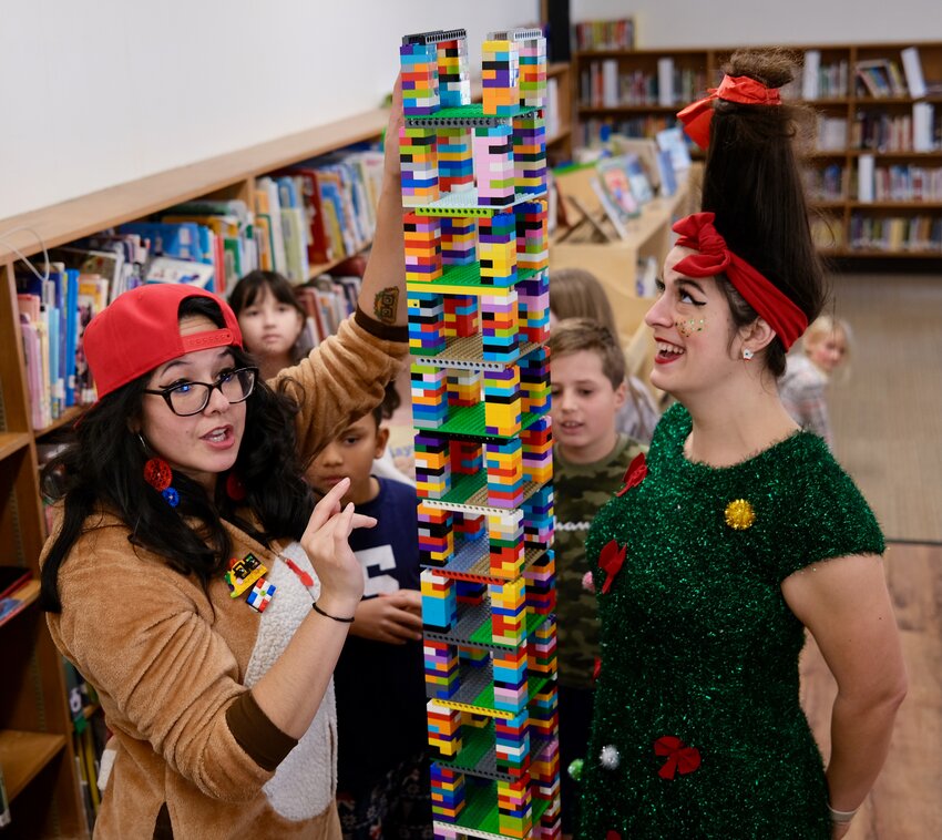 The Lego skyscraper that Hathaway School third-graders built last Thursday as part of a STEAM unit was taller than instructional systems coach Sarah Vitale (right) &mdash;&nbsp;including her elf hair. At left is Christine &ldquo;Tacos&rdquo; Blandino, who competed in the &ldquo;Lego Masters&rdquo; TV show and now teaches engineering through Lego-building.