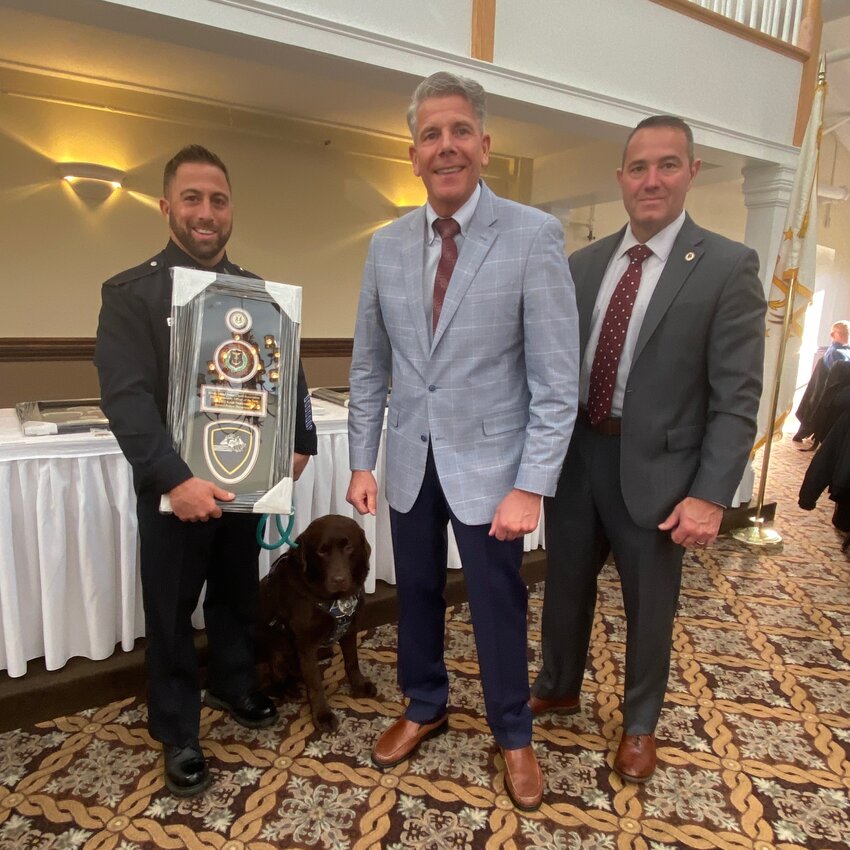 Pictured on the far left is School Resource Officer Keith Medeiros (holding award) along with K9 Brody, Bristol Chief Kevin Lynch, current RIPCA President, and Col. Bradford Connor of Warwick, incoming RIPCA President.
