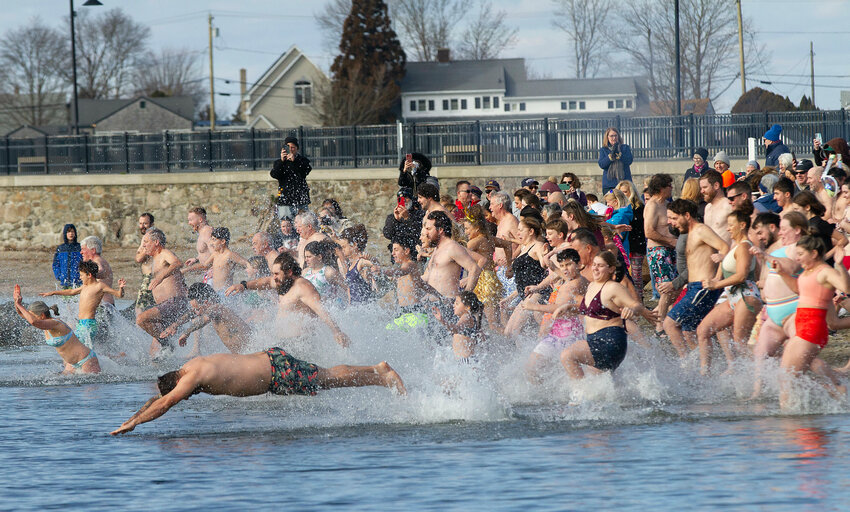 About 100 plungers christened 2024 with a bath at Grinnell's Beach Monday.