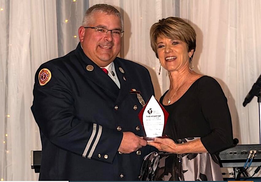 East Providence Fire Department Captain John Potvin receives the American Heart Association's Yvonne Heredia Lifetime Achievement Award from Jennifer Hauck, Senior Vice President of Development &amp; Region Corporate Relations for organization.