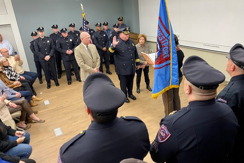 Westport Police Chief Christopher Dunn was sworn in Monday evening by town clerk Kristin Swinson. His mother, Jacqueline Dunn, is to his left and brother-in-law Stephen Griswold to his right.