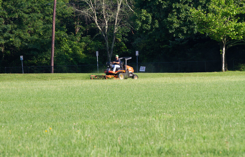 A DPW worker mows the grass at Chianese Park last summer.