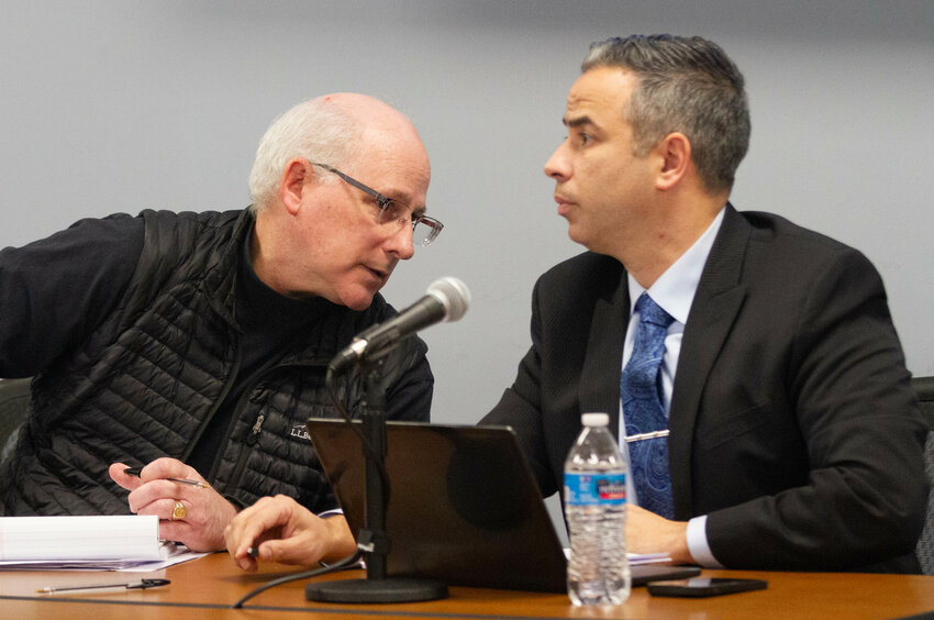 Town Planner Herb Durfee III consults with assistant town solicitor Benjamin Ferreira during the procedural hearing Monday night discussing the reconsideration of the Penny Lane development.