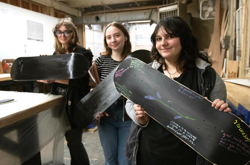 Reese Reardon, 15, (left), Emma Russell, 15, and Toby Matias, 17, hold up their boards.