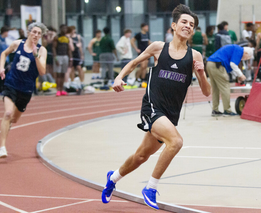 Everson Goglia speeds around the track during the 300 meter run at the Division Championships at the PCTA on Tuesday night.