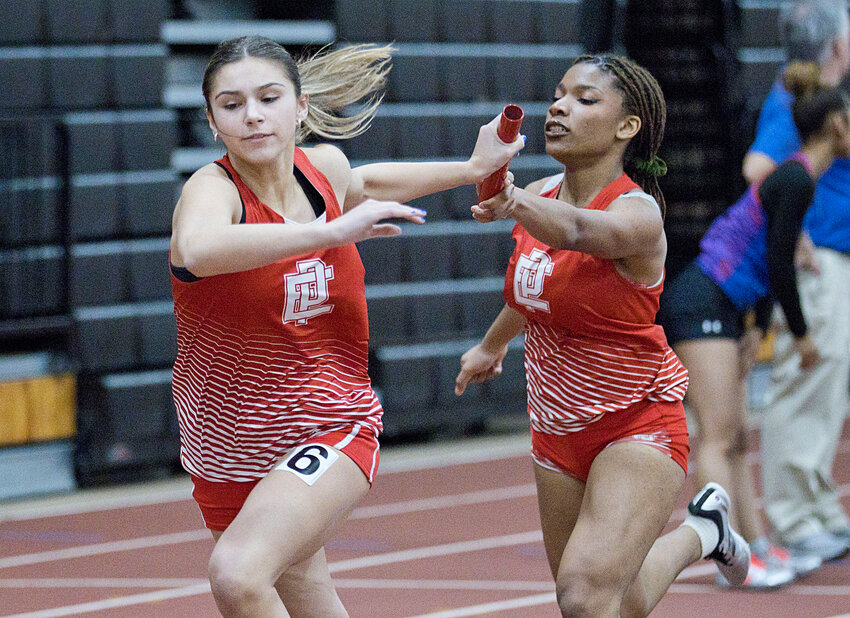 Samantha Clarke (left) takes the baton from Kendra Daniel for the EPHS girls' indoor track and field squad during a 4x4 relay earlier in the winter.