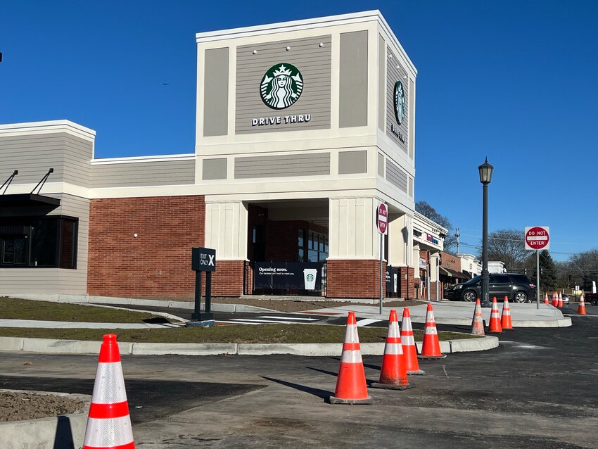 Orange traffic cones block the entrance and exit for the new Starbucks drive-through lane in the Barrington Shopping Center. Officials said the drive-through lane was expected to open on Tuesday, Feb. 27.