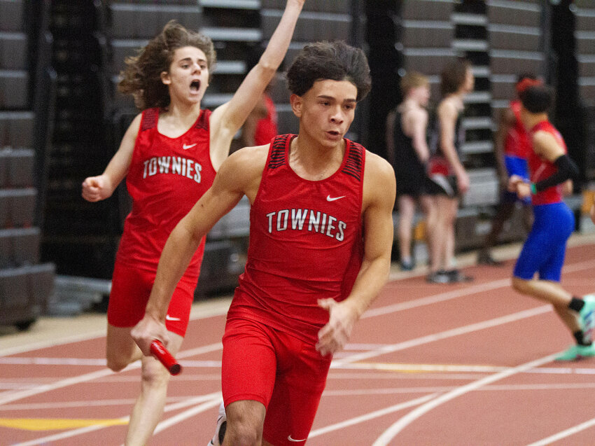 Jack Pawlik (left) and Julius Cortes run the 4x200 meter for the EPHS boys' indoor track team during a meet earlier this winter.
