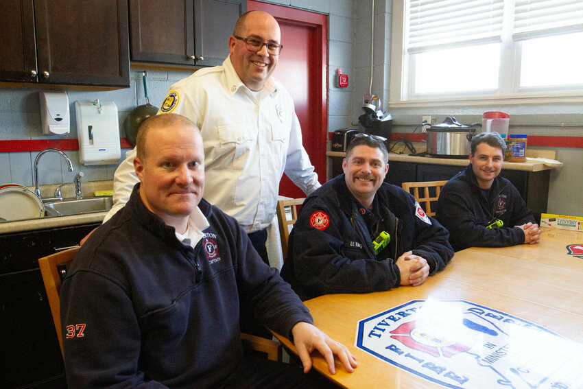 Deputy Tiverton Fire Chief Joshua Ferreira (standing) with Captain Peter Manchester, Lt. James Vaughan and firefighter Austin Daniels in the lunch room of the department headquarters on North Main Street.&nbsp;