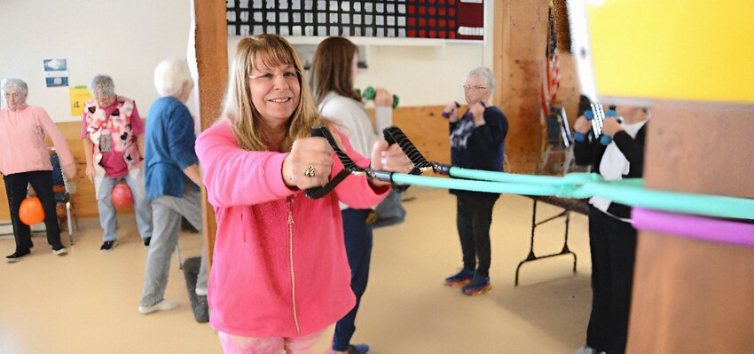 Warren resident Sharon Connolly (nearest camera) takes full advantage of what the Warren Senior Center Strength and Balance Class has to offer.