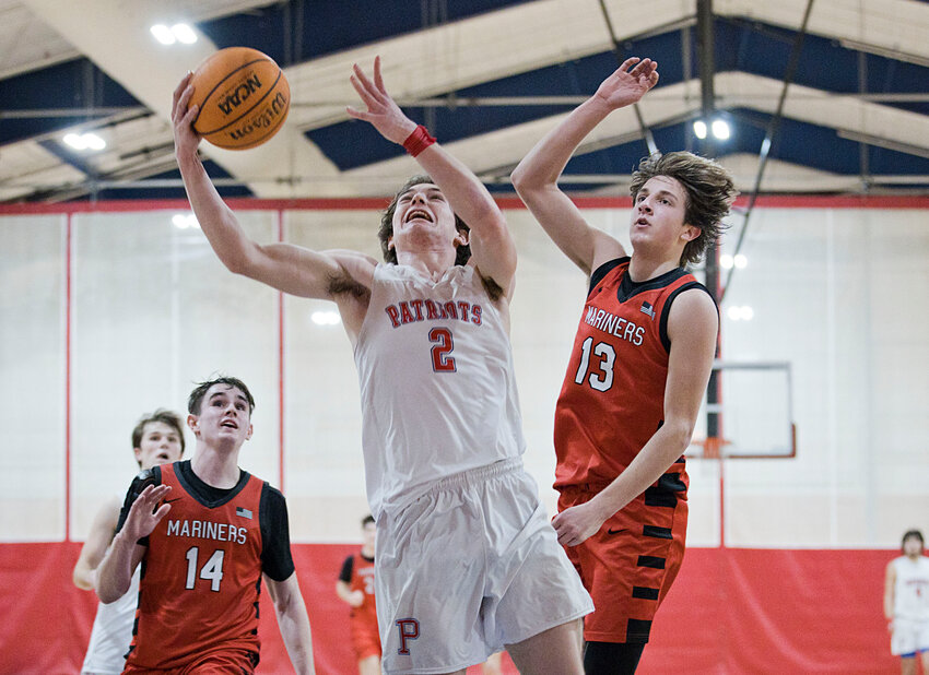 Portsmouth High&rsquo;s Tyler Hurd goes in for a layup while battling Narragansett in overtime Thursday night. The Patriots were victorious, 64-60, to advance to the Division I quarterfinals.