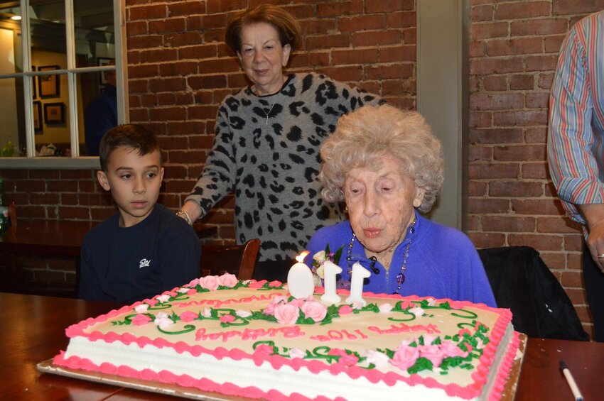 Georgie Gatos and Tula Gatos watch Genevieve Marszalek blow out the candles in honor of the latter's 110th birthday!