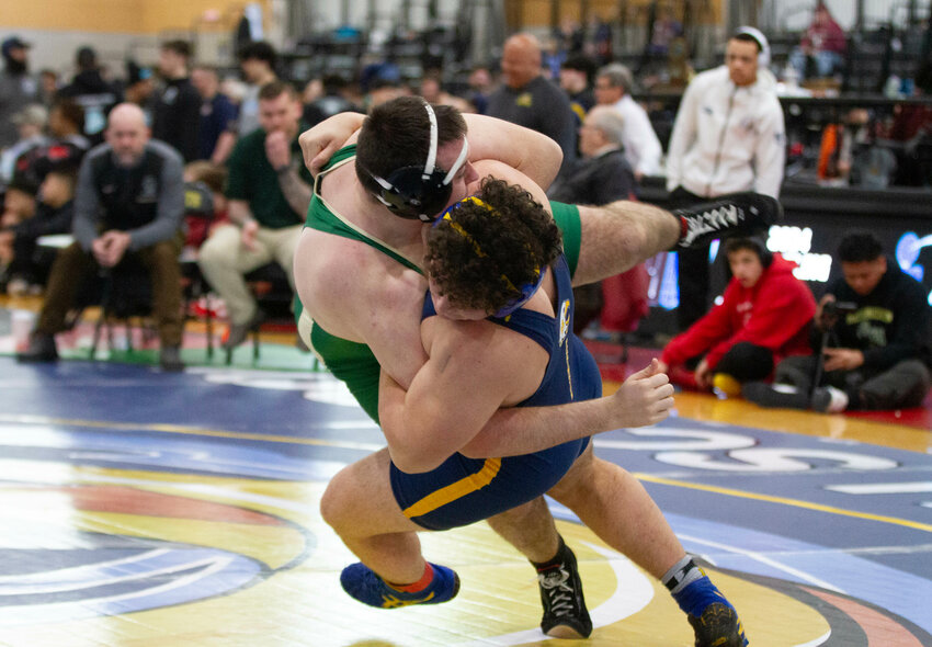 Barrington High School&rsquo;s Matthew Zimmerman (right) throws Hendricken&rsquo;s Hunter Hennessey in a match during the state wrestling tournament. Zimmerman defeated Hennessey and four other competitors and powered to a third place finish in the 215-pound weight class.