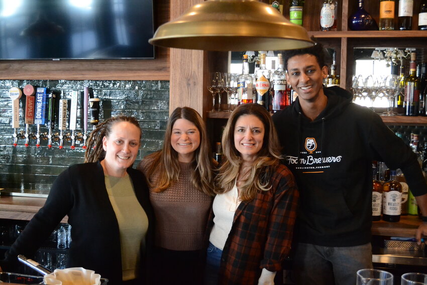 Left to right: Stingy Alley manager Laura Craveiro, The Square Peg manager Kelsey Hughes, restaurateur Amy Cary (owner of Stingy Alley and The Square Peg in Warren and Amy&rsquo;s Place in Providence), and Senai Hagos behind the bar at Stingy Alley, located at 489 Main St.