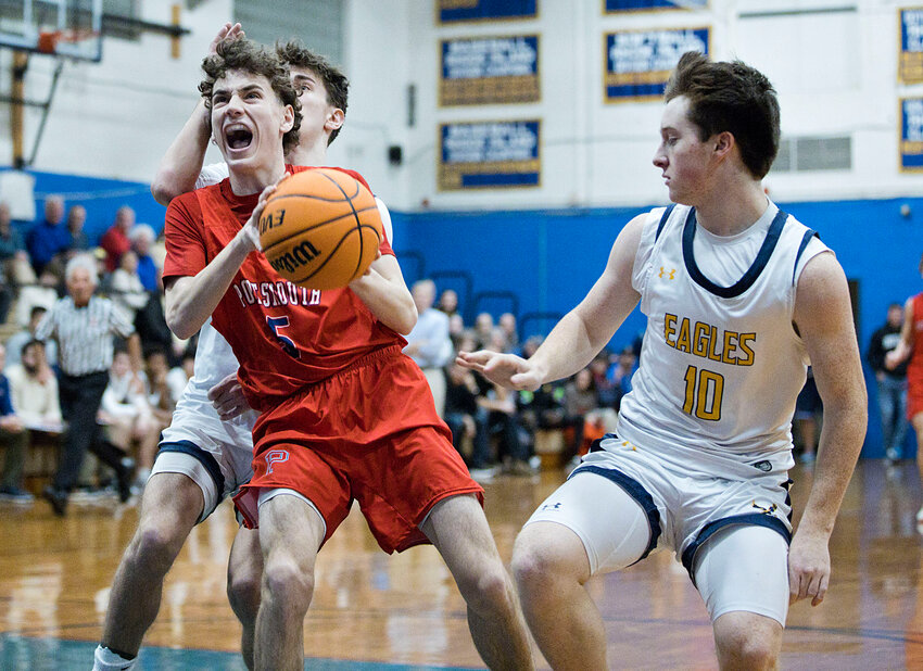 Portsmouth High&rsquo;s Kyle Bielawa splits a pair of Barrington defenders to reach the hoop during Tuesday night&rsquo;s Division I semifinal matchup. The Patriots advanced to the semis with an impressive 79-61 win.