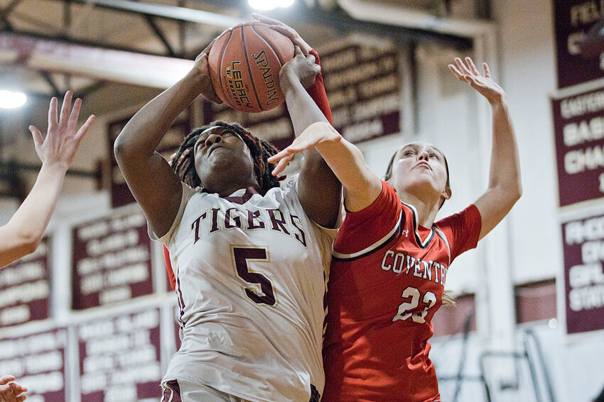 Jah'niece Branch pulled down 10 rebounds for Tiverton against Moses Brown. In photo, she pulls down a rebound during the Tigers' playoff win over Coventry.&nbsp;