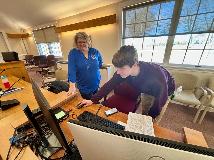 Canvassing Clerk Barbara Sherman shows 17-year-old Maciej Tabak how to navigate the state&rsquo;s Voter Information Center website (vote.sos.ri.gov) after he filled out his voter registration form at Town Hall Sunday. Thanks to a new state law, the Portsmouth High School student will be able to vote in next month&rsquo;s Presidential Primary because he will be 18 by the time of the General Election. He was attending the Portsmouth Board of Canvassers&rsquo; &ldquo;Primaries &amp; Pizza&rdquo; event that featured a presentation about the elections.