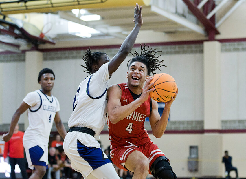 East Providence High School's Levi Jacobs takes contact from a Classical defender while going up for a shot during the teams' Boys' Open State Basketball Tournament quarterfinal round game played last week at Rhode Island College.
