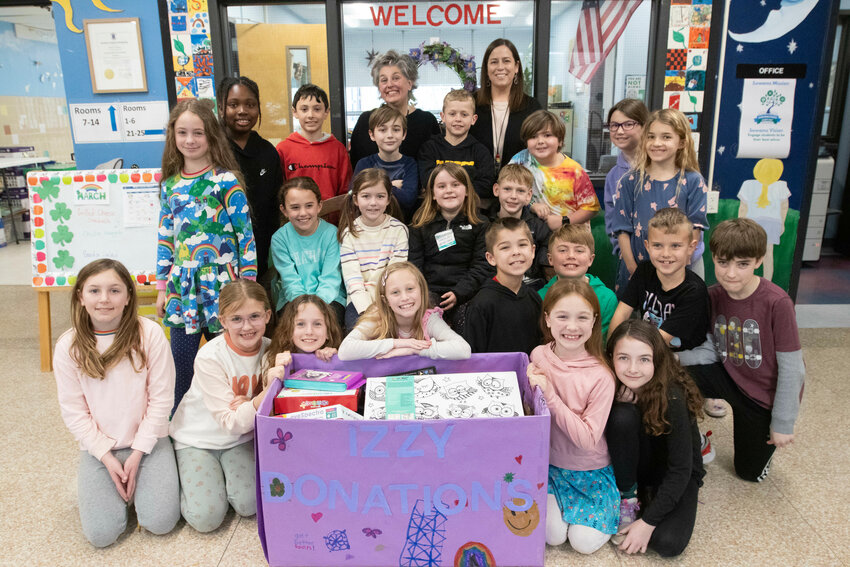 A class of third-graders from Sowams School surrounds the donation box set aside for items that will be sent to the Izzy Room at Hasbro Children&rsquo;s Hospital. The students&rsquo; teachers, Rachel Lally (back row, left) and Ashley Adamson (back row, right) said the students also made pillows and wrote notes for those at the Izzy Room.