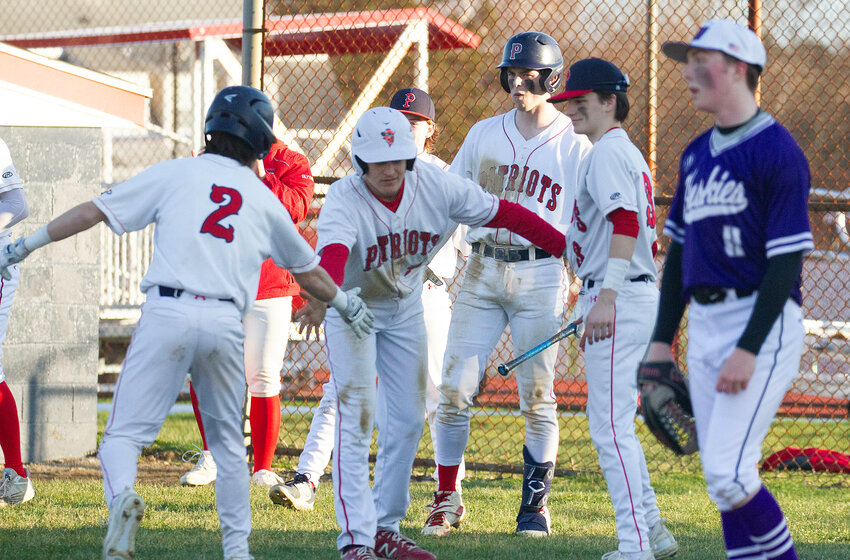 Casey Cord (left) and Cam Ruggieri (middle) celebrate they both score on a John Mass double in the sixth inning against Mt. Hope on Monday, as teammates Nick Spaner (mid-right) and Charlie Cord (right) look on.
