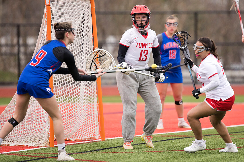 East Providence High School's Ava Williams (goalie) and Jayla DaGraca defend against Mount St. Charles during the Townies' 2024 home opener Friday, April 5.