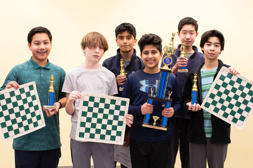 Barrington Middle School chess team members Nathaniel Sarkar, Samuel Ellis, Divyansh Yadav, Arjun Bansal, Albert Dong and Luke Cladis (from left to right) hold chess boards and their trophies &mdash; the first-year team recently won the State Chess Championship.