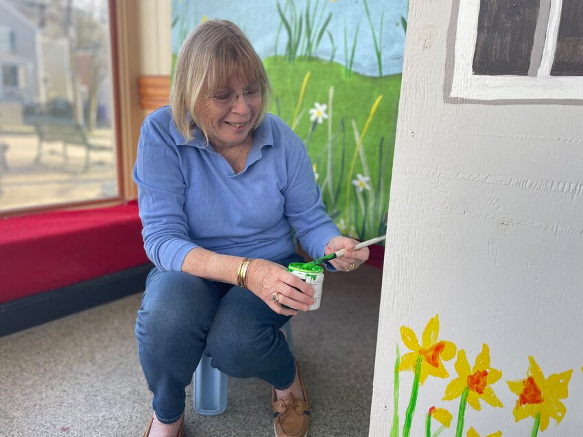 Gail Burmeister, president of the Bristol Garden Club, decorates a display in a storefront at Hope and State Streets in anticipation of &lsquo;Daffodils Downtown&rsquo;, a celebration of the 30,000 daffodils planted to date since the launch of the Daffodil Project in 2020.